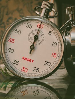 A detailed shot of a vintage analog stopwatch showing reflection. Perfect for time-related themes.